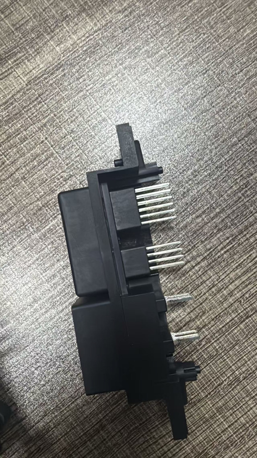 Close view of a molded component with metal terminals