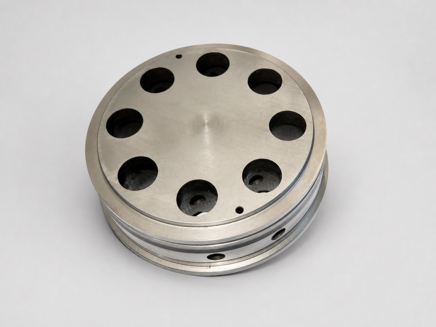 Precision mold component on a clean inspection background