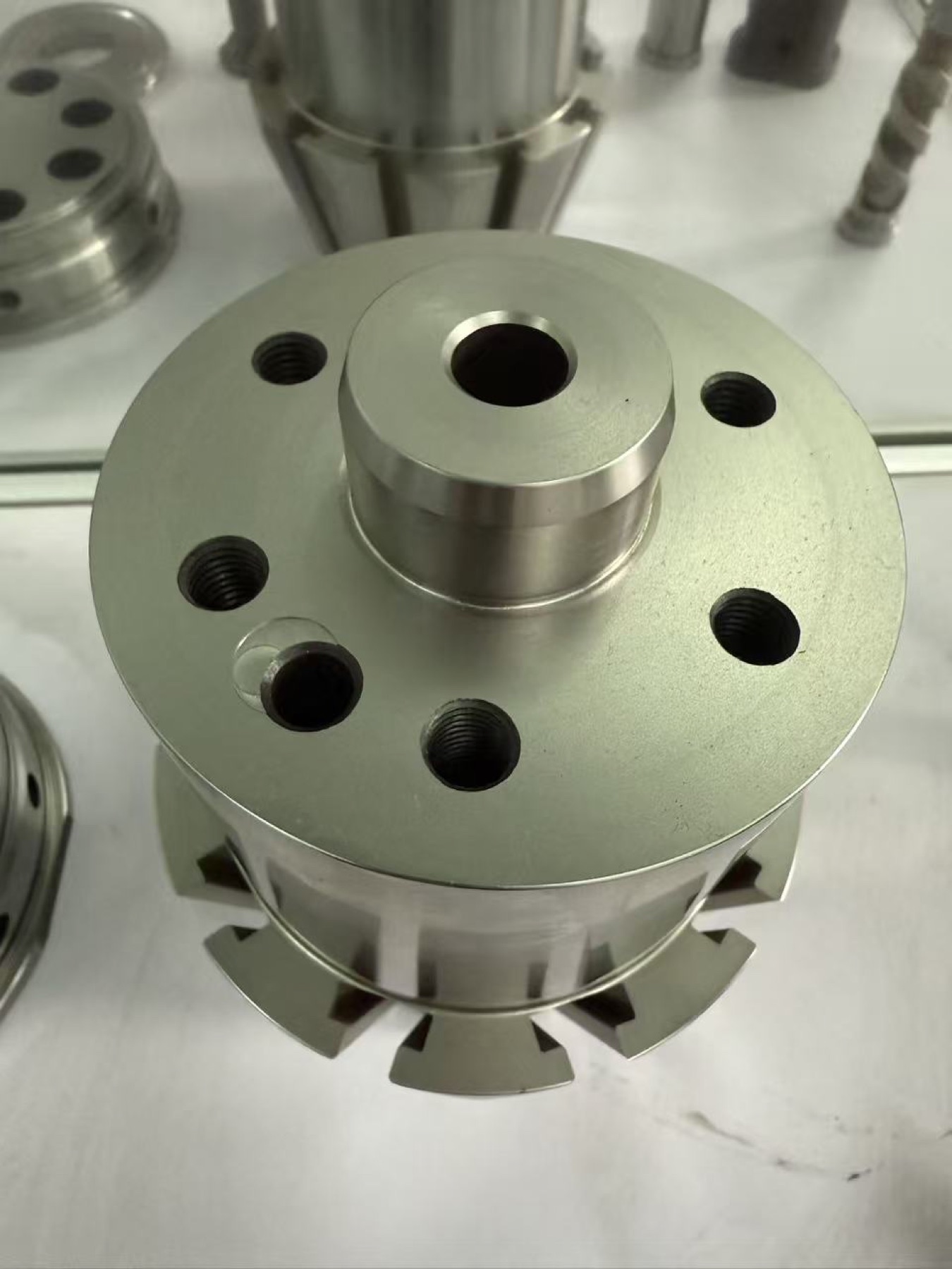 Round precision component with radial machined features