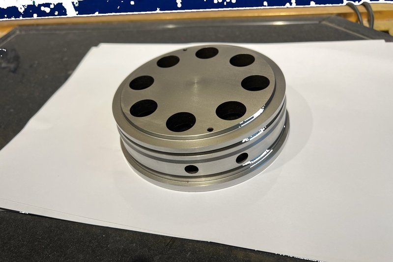 Precision circular mold component with symmetrical hole pattern