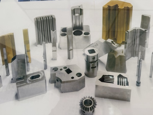Tin-coated precision mold components showing various insert and core geometries