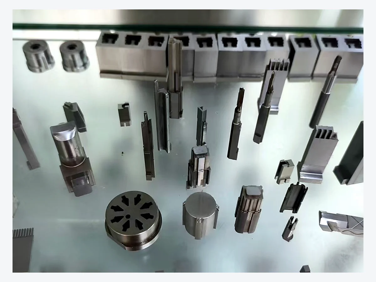 Representative precision mold components displayed in Huicheng's sample cabinet